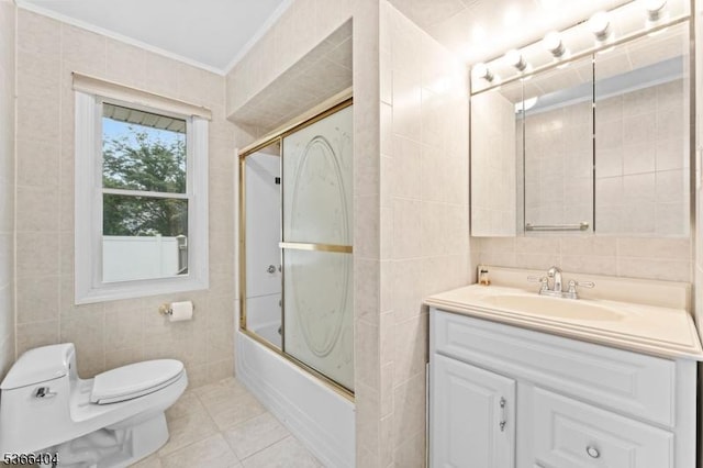 88 San Antonio Ave, Nutley Twp, NJ 07110 - bathroom with tile walls, vanity, crown molding, bath / shower combo with glass door, and tile patterned floors
