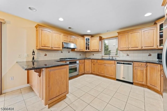 88 San Antonio Ave, Nutley Twp, NJ 07110 - kitchen featuring appliances with stainless steel finishes, under cabinet range hood, a peninsula, glass insert cabinets, and light tile patterned flooring