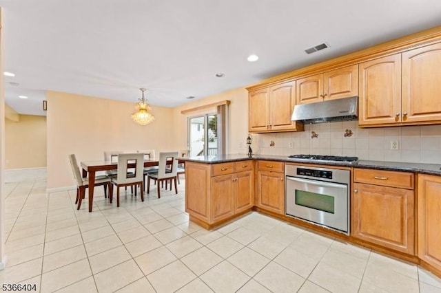 88 San Antonio Ave, Nutley Twp, NJ 07110 - kitchen featuring appliances with stainless steel finishes, under cabinet range hood, tasteful backsplash, a peninsula, and pendant lighting