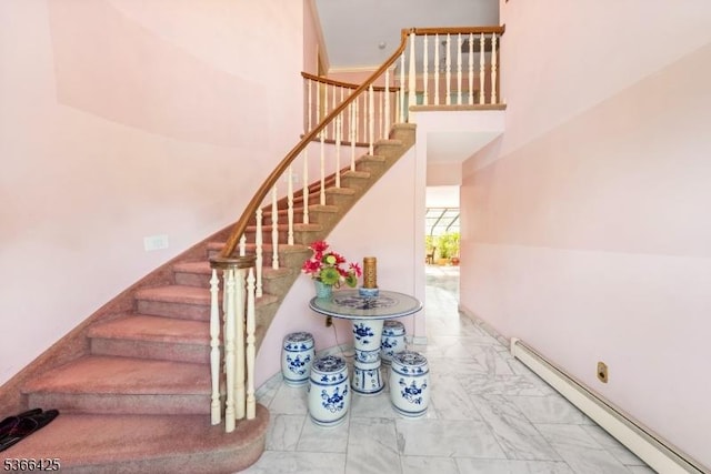 444 Harrison Ave, Lodi Boro, NJ 07644 - stairs with a baseboard heating unit, marble finish floors, and a towering ceiling