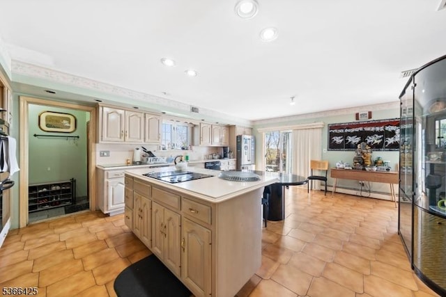 444 Harrison Ave, Lodi Boro, NJ 07644 - kitchen with black electric stovetop, a baseboard heating unit, freestanding refrigerator, light countertops, and a center island