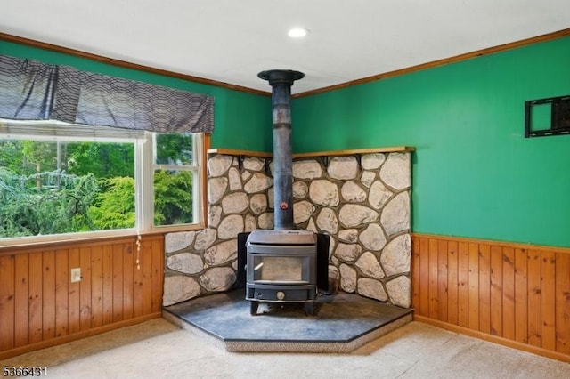 240 Free Union Rd, Liberty Twp, NJ 07838 - detailed view of a wood stove, wooden walls, a wainscoted wall, ornamental molding, and carpet flooring