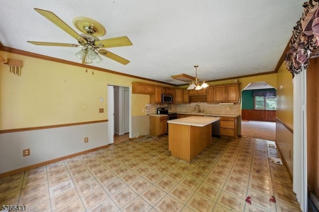240 Free Union Rd, Liberty Twp, NJ 07838 - kitchen with crown molding, stainless steel appliances, light countertops, arched walkways, and a kitchen island