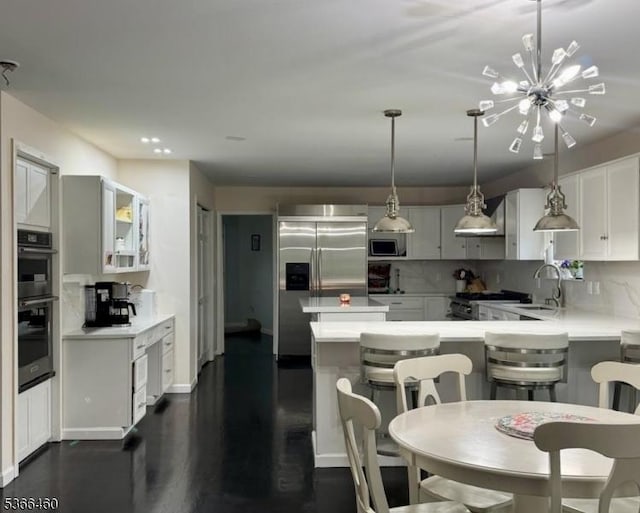 710 County Road 513, Alexandria Twp, NJ 08867 - kitchen with appliances with stainless steel finishes, tasteful backsplash, light countertops, a chandelier, and recessed lighting
