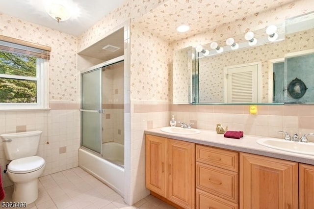 10 Cross Way, New Providence Boro, NJ 07974 - full bath with tile walls, tile patterned flooring, double vanity, wainscoting, and combined bath / shower with glass door