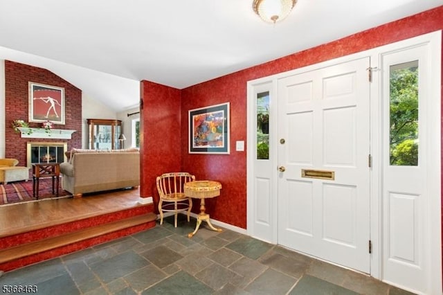 10 Cross Way, New Providence Boro, NJ 07974 - foyer featuring dark stone finish floors, lofted ceiling, and a fireplace