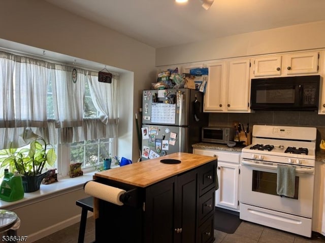 337 Smithwold Rd, Franklin Twp, NJ 08873 - kitchen featuring black microwave, white range with gas cooktop, freestanding refrigerator, white cabinetry, and butcher block countertops
