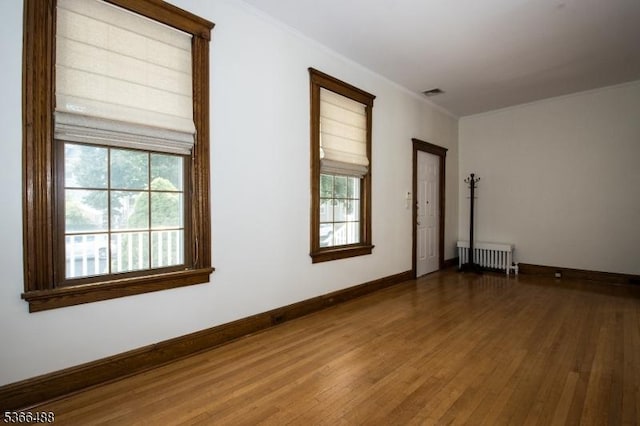 219 Magie Ave, Roselle Park Boro, NJ 07204 - unfurnished room with radiator, wood finished floors, healthy amount of natural light, and crown molding