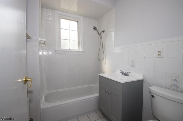 219 Magie Ave, Roselle Park Boro, NJ 07204 - bathroom featuring vanity,  shower combination, tile walls, tile patterned flooring, and wainscoting