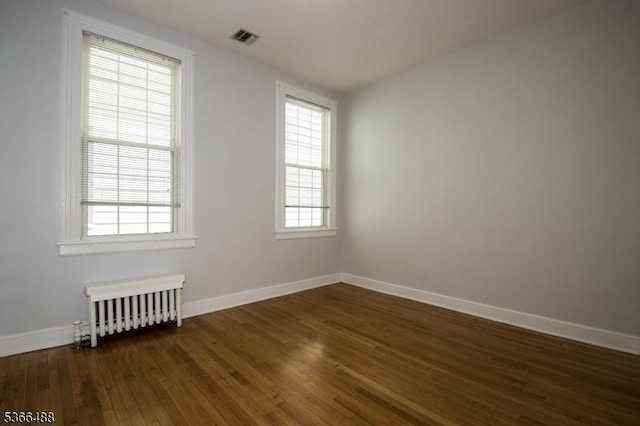 219 Magie Ave, Roselle Park Boro, NJ 07204 - empty room with radiator and dark wood finished floors