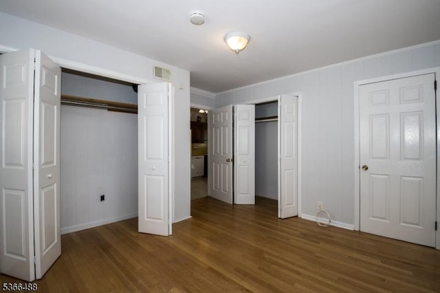 219 Magie Ave, Roselle Park Boro, NJ 07204 - unfurnished bedroom with two closets, wood finished floors, and crown molding
