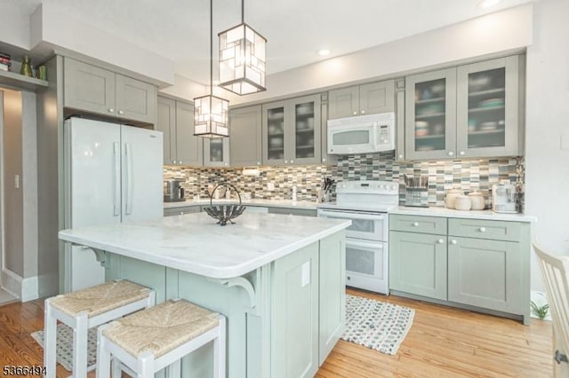 151 N Union St Unit 6, Lambertville City, NJ 08530 - kitchen with white appliances, light countertops, decorative light fixtures, a breakfast bar, and recessed lighting