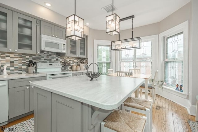 151 N Union St Unit 6, Lambertville City, NJ 08530 - kitchen with gray cabinets, white appliances, decorative backsplash, a breakfast bar, and recessed lighting