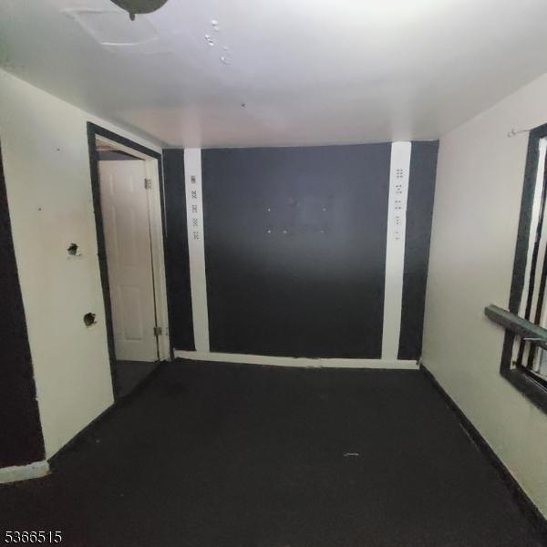 471 S 16th St, Newark City, NJ 07103 - empty room featuring dark carpet