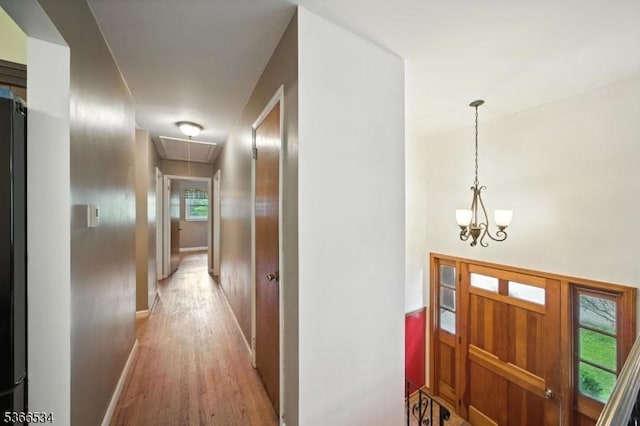 54 Pine Ln, West Milford Twp, NJ 07480 - corridor featuring attic access, wood finished floors, a chandelier, and healthy amount of natural light