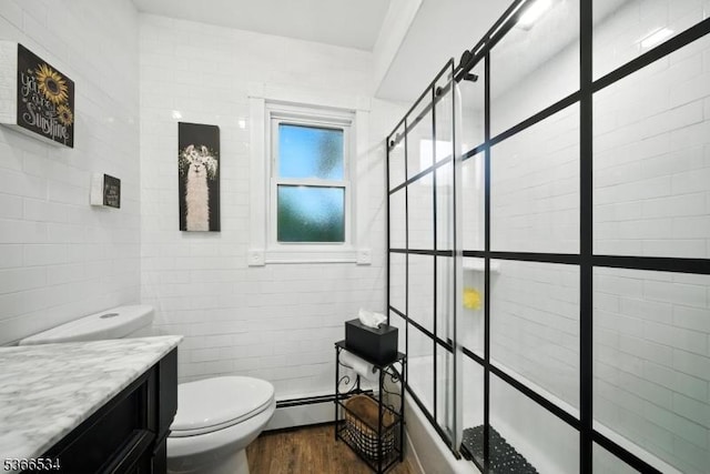 54 Pine Ln, West Milford Twp, NJ 07480 - bathroom with vanity, a baseboard radiator, wood finished floors, and shower / bath combination with glass door
