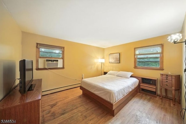 54 Pine Ln, West Milford Twp, NJ 07480 - bedroom with a baseboard heating unit, cooling unit, and wood finished floors