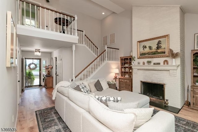 11 Killdeer Dr, Allamuchy Twp, NJ 07840 - living room featuring wood finished floors, a high ceiling, stairs, a fireplace, and recessed lighting