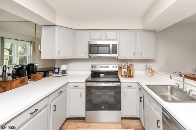 11 Killdeer Dr, Allamuchy Twp, NJ 07840 - kitchen with appliances with stainless steel finishes, light countertops, white cabinets, and a peninsula