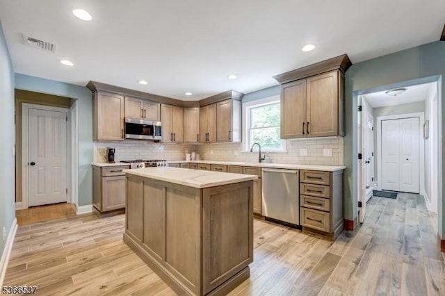 19 Mountain Ridge Dr, Wayne Twp, NJ 07470 - kitchen featuring appliances with stainless steel finishes, light countertops, light wood finished floors, tasteful backsplash, and recessed lighting