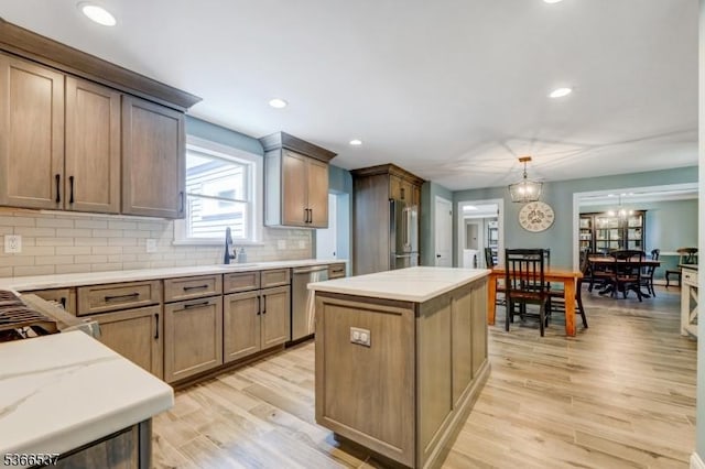 19 Mountain Ridge Dr, Wayne Twp, NJ 07470 - kitchen featuring stainless steel appliances, light wood finished floors, backsplash, a kitchen island, and pendant lighting