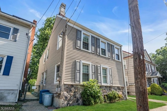 853 Westfield Ave, Rahway City, NJ 07065 - view of front facade with a gate, a front yard, and stone siding