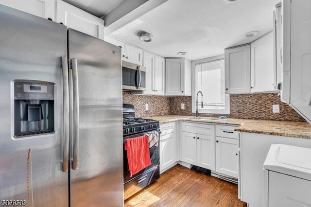 853 Westfield Ave, Rahway City, NJ 07065 - kitchen featuring stainless steel appliances, light wood-style floors, white cabinetry, and light stone countertops