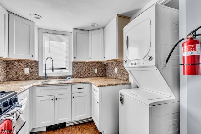853 Westfield Ave, Rahway City, NJ 07065 - washroom with estacked washer and dryer and dark wood-style floors