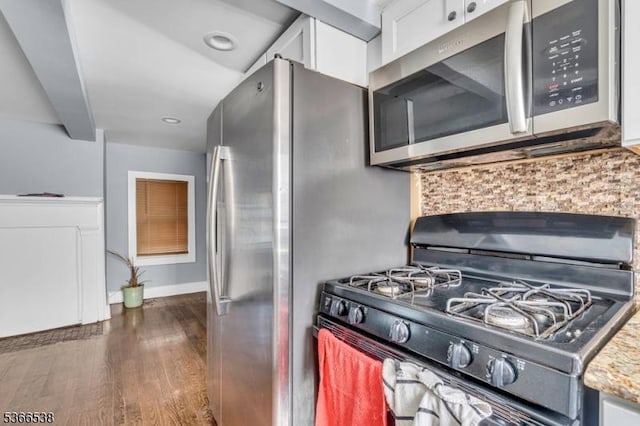 853 Westfield Ave, Rahway City, NJ 07065 - kitchen featuring stainless steel microwave, range with gas cooktop, tasteful backsplash, white cabinetry, and dark wood finished floors