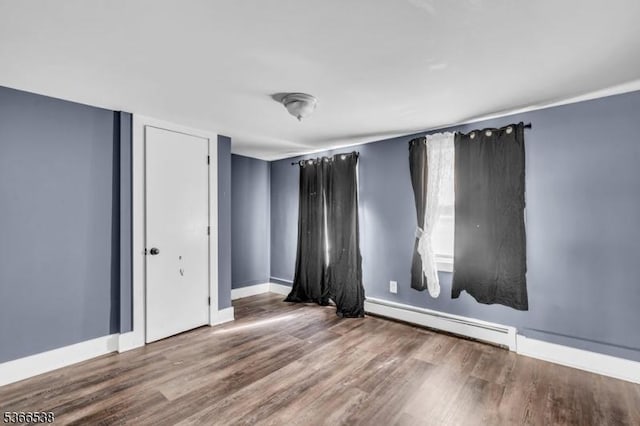 853 Westfield Ave, Rahway City, NJ 07065 - empty room with a baseboard radiator and wood finished floors