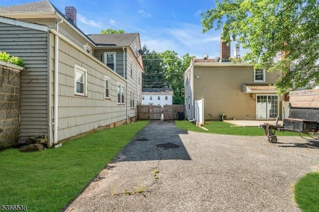 853 Westfield Ave, Rahway City, NJ 07065 - view of home's exterior featuring asphalt driveway and a patio area