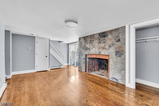 853 Westfield Ave, Rahway City, NJ 07065 - unfurnished living room with a fireplace, stairway, wood finished floors, and a baseboard heating unit