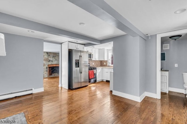 853 Westfield Ave, Rahway City, NJ 07065 - kitchen with stainless steel appliances, white cabinetry, wood finished floors, light countertops, and a baseboard heating unit