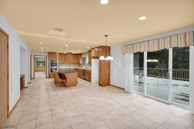 86 Underrock Rd, Sparta Twp, NJ 07871 - kitchen featuring appliances with stainless steel finishes, decorative backsplash, a kitchen island, a chandelier, and brown cabinets
