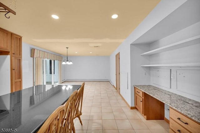 86 Underrock Rd, Sparta Twp, NJ 07871 - kitchen with open shelves, light stone countertops, built in desk, light tile patterned flooring, and brown cabinetry