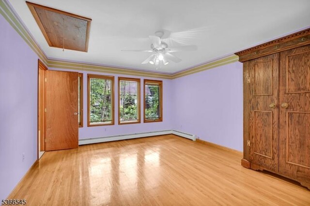 86 Underrock Rd, Sparta Twp, NJ 07871 - unfurnished bedroom featuring a baseboard heating unit, attic access, light wood-style floors, crown molding, and ceiling fan