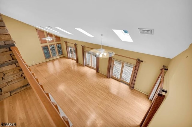 86 Underrock Rd, Sparta Twp, NJ 07871 - unfurnished living room featuring a skylight, vaulted ceiling, light wood-style floors, and stairs