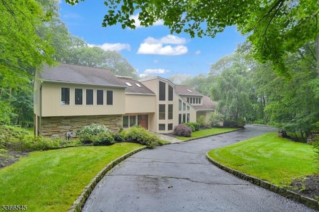 86 Underrock Rd, Sparta Twp, NJ 07871 - view of front of home with stone siding, a front yard, and asphalt driveway