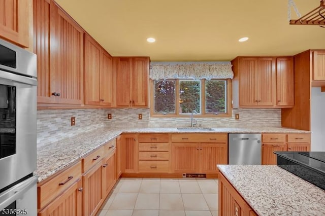 86 Underrock Rd, Sparta Twp, NJ 07871 - kitchen with stainless steel appliances, decorative backsplash, light stone counters, recessed lighting, and light tile patterned flooring