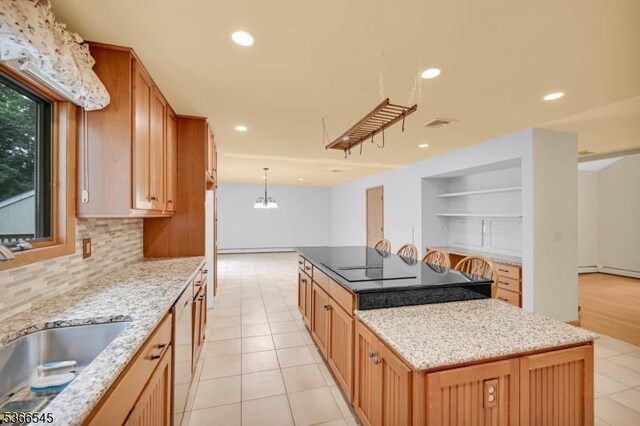 86 Underrock Rd, Sparta Twp, NJ 07871 - kitchen featuring a kitchen island, decorative backsplash, a chandelier, light stone countertops, and light tile patterned floors
