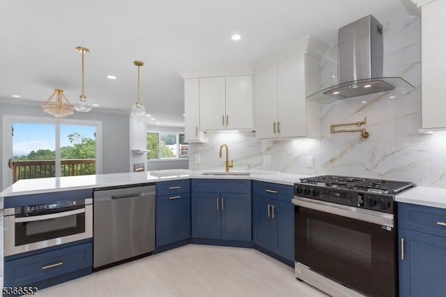 604 Skyline Dr Unit 604, Haledon Boro, NJ 07508 - kitchen featuring stainless steel appliances, wall chimney exhaust hood, blue cabinets, white cabinetry, and ornamental molding