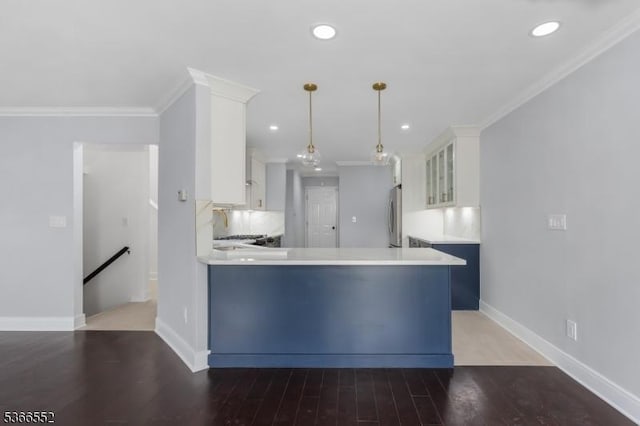 604 Skyline Dr Unit 604, Haledon Boro, NJ 07508 - kitchen with freestanding refrigerator, light countertops, white cabinetry, wood finished floors, and a peninsula