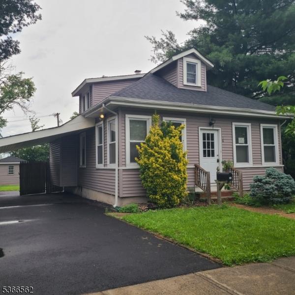 16 Ransome Pl, Plainfield City, NJ 07063 - view of front of home with an attached carport, a shingled roof, a front lawn, and driveway