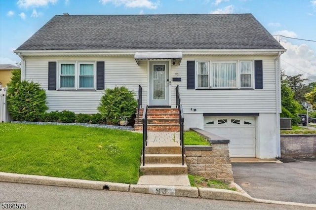 93 Meacham Ave, Nutley Twp, NJ 07110 - view of front of home featuring an attached garage, a shingled roof, a front yard, and asphalt driveway