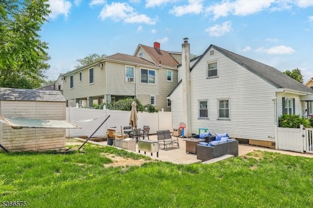 93 Meacham Ave, Nutley Twp, NJ 07110 - rear view of property featuring a patio, a fenced backyard, an outdoor living space, and a storage unit