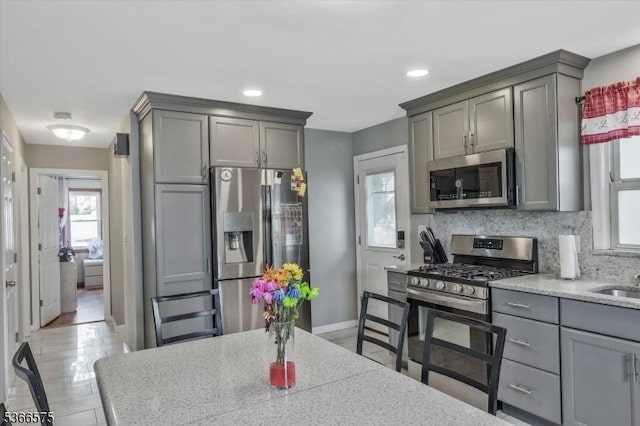 93 Meacham Ave, Nutley Twp, NJ 07110 - kitchen featuring appliances with stainless steel finishes, gray cabinetry, tasteful backsplash, and recessed lighting