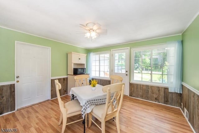 21 Benton Rd, Blairstown Twp, NJ 07832 - dining area with light wood-style floors, wainscoting, crown molding, wood walls, and ceiling fan