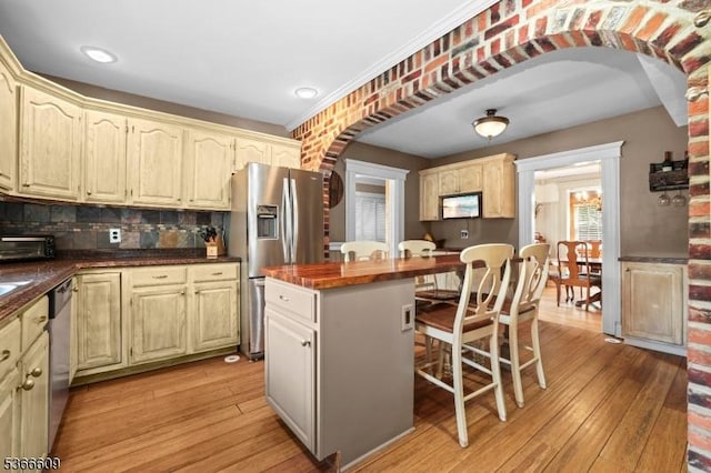 169 Knoll Rd, Parsippany-Troy Hills Twp, NJ 07005 - kitchen featuring arched walkways, stainless steel appliances, a breakfast bar area, light wood-type flooring, and recessed lighting