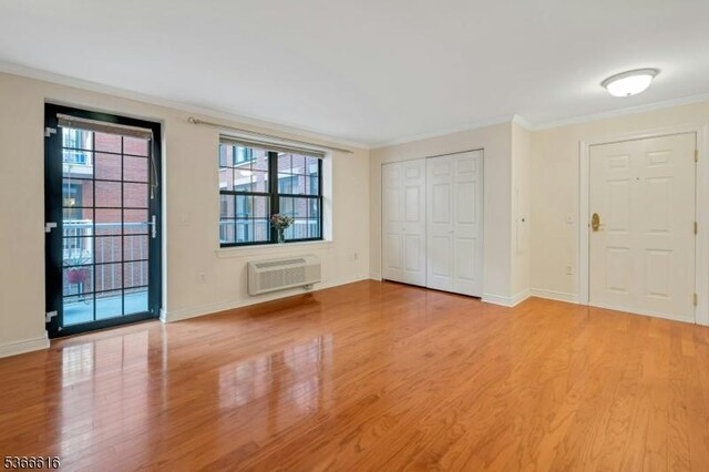 7 Prospect St Unit 510, Morristown Town, NJ 07960 - foyer entrance featuring an AC wall unit, ornamental molding, and light wood-type flooring