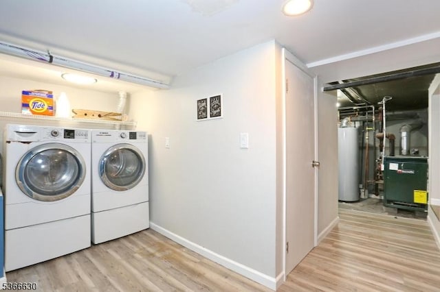393 High St, Nutley Twp, NJ 07110 - laundry area featuring water heater, washing machine and clothes dryer, wood finished floors, and a heating unit